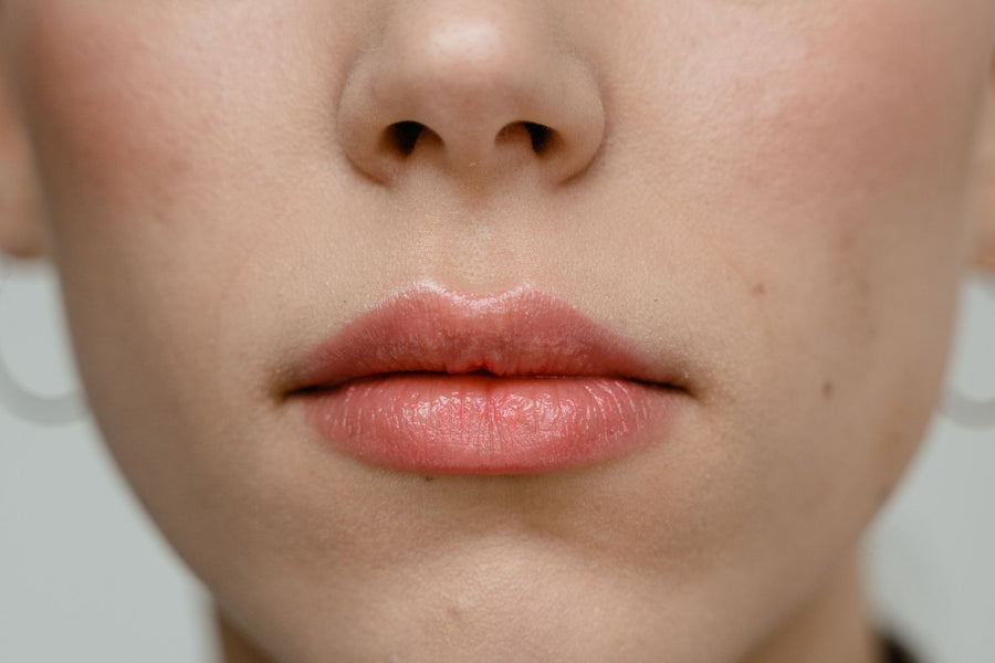 Person applying cold sore cream to their lip at the first sign of tingling